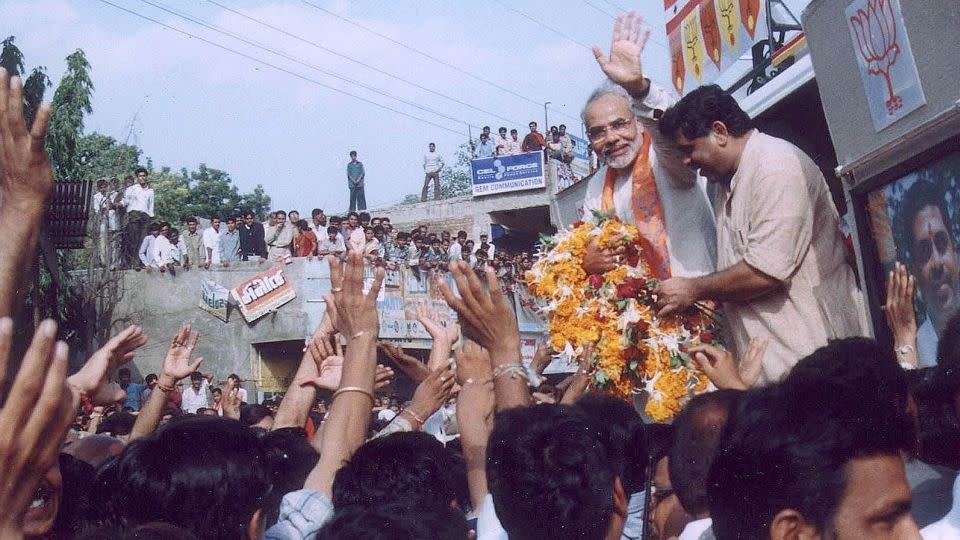 Then Gujarat Chief Minister Narendra Modi waves to supporters in Kadi, Gujarat state, on September 9, 2002. - Amit Dave/Reuters
