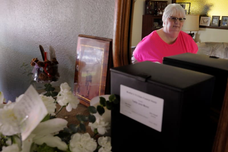 Debbie de los Angeles, whose mother died from coronavirus disease, poses for a portrait at her home in Monroe