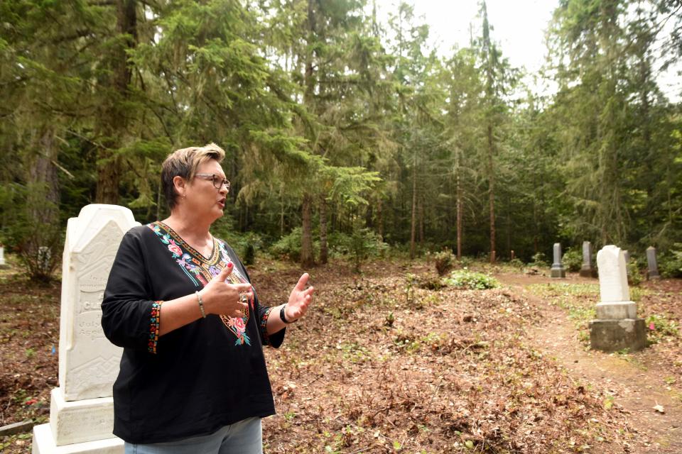 Candace Kolbas gives a tour at the Seabeck Cemetery to introduce the Seabeck Cemetery Restoration Project, in which volunteers clear the salal and wild shrubs at the cemetery, find graves, and restores damaged headstones. Kolbas, who lives in Silverdale, is co-chair of the project and chapter registrar of Elizabeth Ellington Chapter, National Society Daughters of the American Revolution.