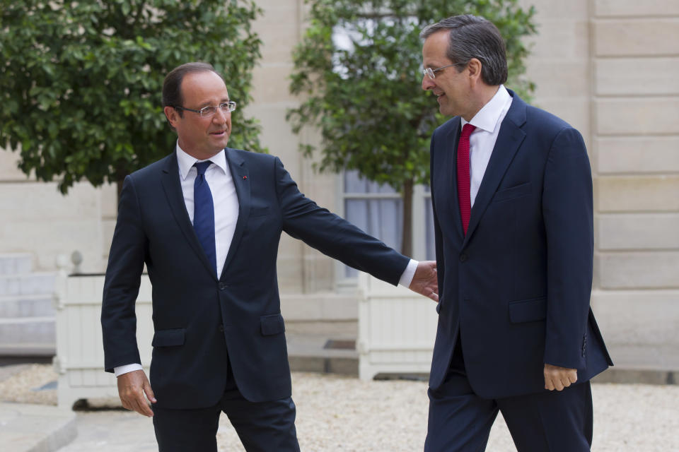 France’s President Francois Hollande, left, welcomes Greece's Prime Minister Antonis Samaras at the Elysee Palace, Saturday, Aug. 25, 2012. As the country's Prime Minister, Antonis Samaras, heads around Europe for top-level talks on Greece's attempts to right its finances, austerity-weary Greeks back home are preparing themselves for new pain amid fears that they may be kicked out of the 17-country group that uses the euro. (AP Photo/Michel Euler)