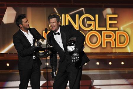 Show hosts Luke Bryan (L) and Blake Shelton, dressed as Daft Punk, address the audience at the 49th Annual Academy of Country Music Awards in Las Vegas, Nevada April 6, 2014. REUTERS/ Robert Galbriath