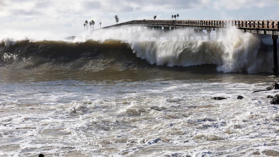 PHOTO: A lone surfer is silhouetted in the surf at Rincon Point in Santa Barbara, California, Dec. 30, 2023. (Amy Katz/Zuma Press)