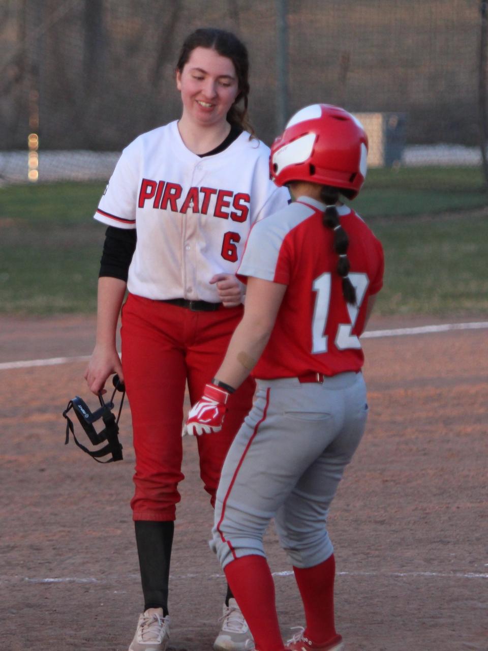 Canton's Emily Cole (13) checks on Pinckney pitcher Emma Arnold (6) after hitting her with a line drive in the sixth inning of the second game on Monday, April 10, 2023.