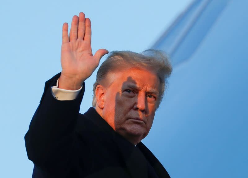 U.S. President Donald Trump boards Air Force One beside first lady Melania Trump at Joint Base Andrews in Maryland