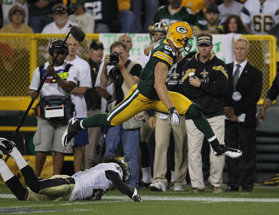 GREEN BAY, WI - SEPTEMBER 08: Jordy Nelson #87 of the Green Bay Packers leaps over Tracy Porter #22 of the New Orleans Saints during the NFL opening season game at Lambeau Field on September 8, 2011 in Green Bay, Wisconsin. The Packers defeated the Saints 42-34. (Photo by Jonathan Daniel/Getty Images)