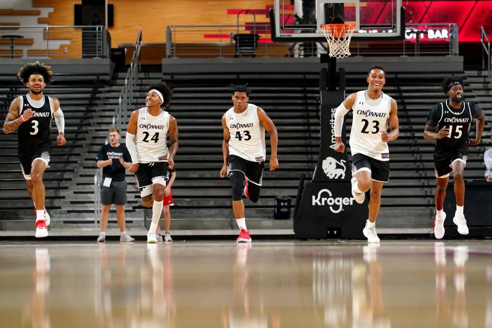 From left: Cincinnati Bearcats guards Mike Saunders Jr., Jeremiah Davenport, Rob Banks, Mike Adams-Woods and wing John Newman III run during practice, Monday, Oct. 4, 2021, at Fifth Third Arena in Cincinnati. 