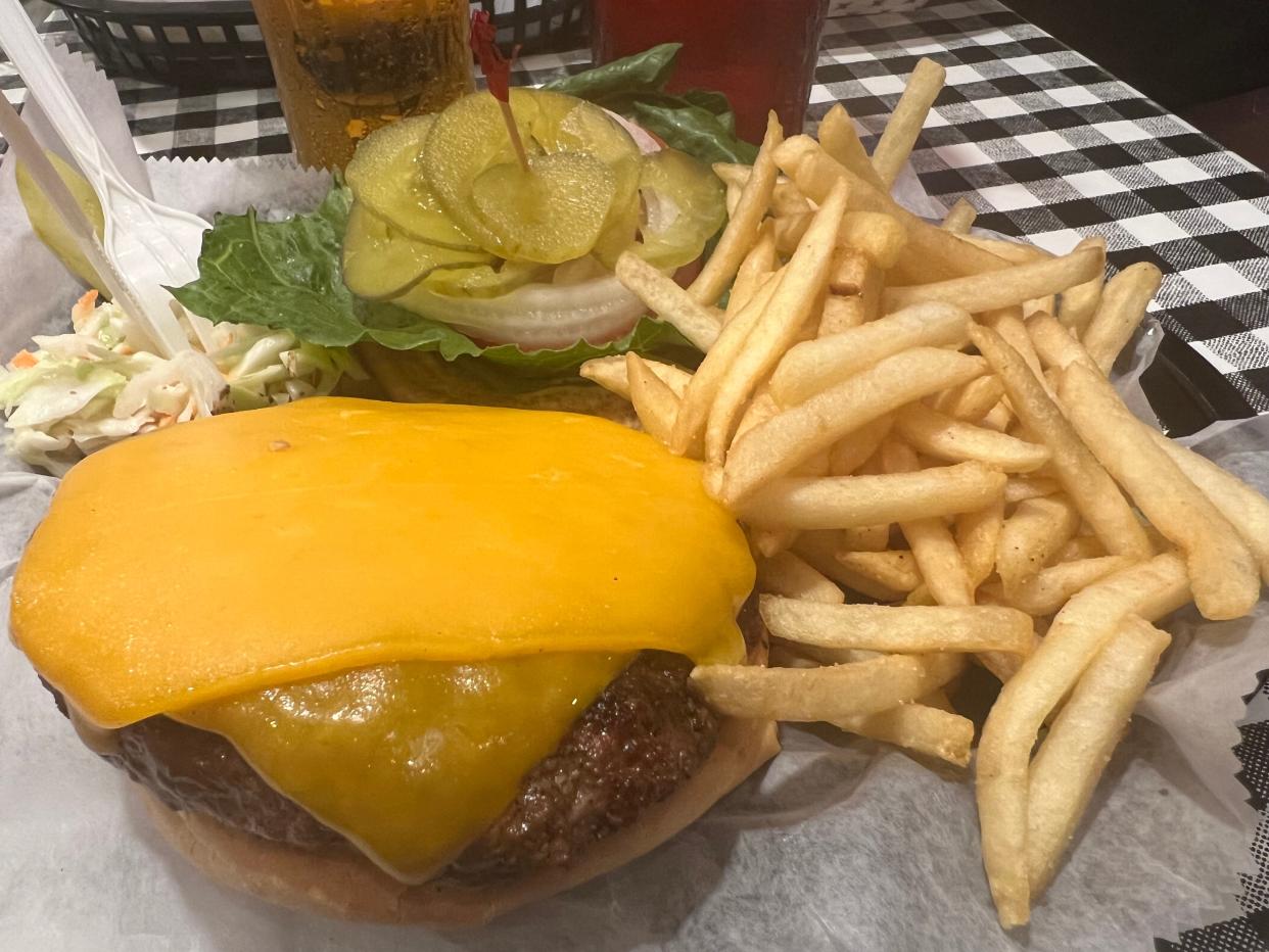 A burger basket with fries and coleslaw is one of the most popular menu items at the Brickyard Lounge & Grill at 747 W. International Speedway Blvd. in Daytona Beach, pictured on Thursday, Aug. 24, 2023. The restaurant which is celebrating its 30th year in business is under contract to be sold at the end of August by founders Renny and Penney Miles.