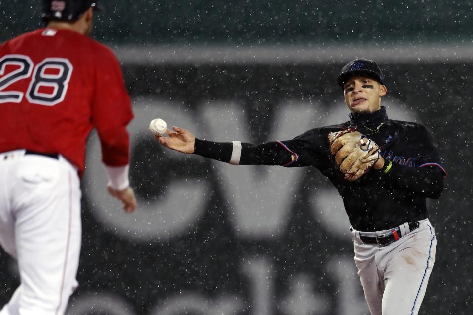 Boston Red Sox's J.D. Martinez (28) is forced out at second base as Miami Marlins' Isan Diaz throws to first base on the single by Xander Bogaerts during the fifth inning of a baseball game, Friday, May 28, 2021, in Boston. (AP Photo/Michael Dwyer)