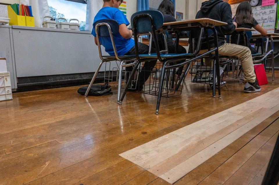 New wooden floorboards are seen in a classroom at Central Middle School on Tuesday, April 16, 2024, in Kansas City, Kansas. The boards were replaced because of water damage.