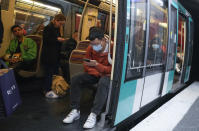 A man wearing a face mask to protect against COVID-19 rides a subway in Paris, Thursday, June 30, 2022. Virus cases are rising fast in France and other European countries after COVID-19 restrictions were lifted in the spring. With tourists thronging Paris and other cities, the French government is recommending a return to mask-wearing in public transport and crowded areas but has stopped short of imposing new rules. (AP Photo/Michel Euler)