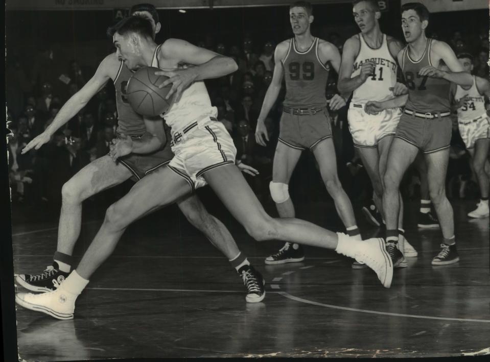 Terry Rand drives under the basket for Marquette in 1955.