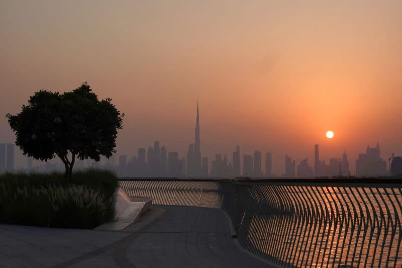 FILE PHOTO: The Burj Khalifa building peaks through the skyline as the sun sets over Dubai