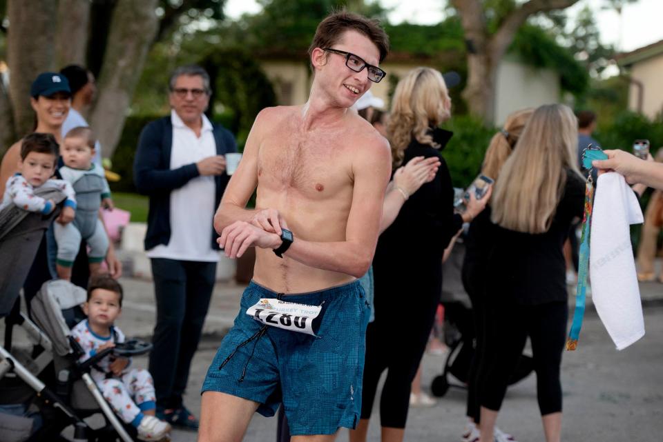 Atticus Stonestrom, 23, of Palm Beach, finishes first in the 5K as over 1,500 people participate in the annual Town of Palm Beach United Way Turkey Trot Thursday at Bradley Park.