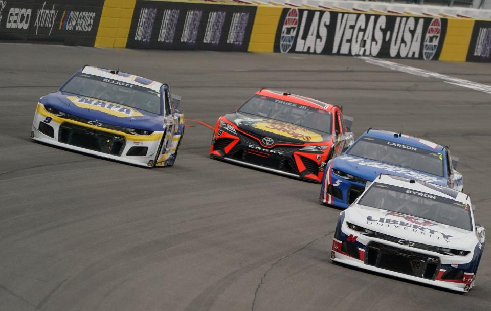 William Byron (24), Kyle Larson (5), Martin Truex Jr. (19) and Chase Elliott (9) race for position during the 2021 Pennzoil 400 at Las Vegas Motor Speedway.