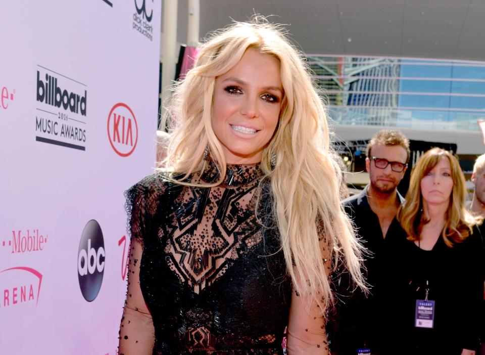 Britney Spears smiles in a black lace dress