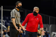 Connecticut head coach Geno Auriemma, right, questions an official after one of his players received a technical foul during the third quarter of an NCAA college basketball game against Butler in Indianapolis, Saturday, Feb. 27, 2021. (AP Photo/Michael Conroy)