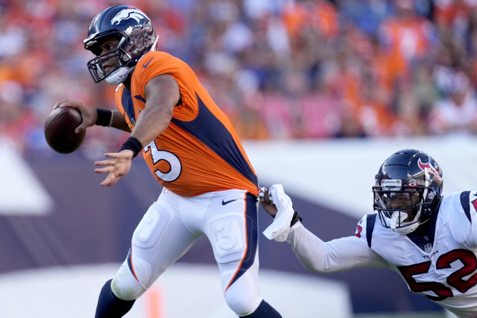 Denver Broncos quarterback Russell Wilson (3) is pressured by Houston Texans defensive end Jonathan Greenard (52) during the second half of an NFL football game, Sunday, Sept. 18, 2022, in Denver. (AP Photo/David Zalubowski)