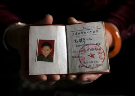 Sun Huanping, 55, shows her dead son's "honourable single child certification" which bears the slogan, "For the revolution, have only one child" at her house in Zhangjiakou, China, November 23, 2015. Sun's son with her 53-year-old husband Li Guoquan, Li Chao, was born in 1987 and died from a car accident in 2013. Sun terminated another pregnancy and couldn't think of having a second child because of the strict application of the one-child policy. After the loss of their son, Sun has suffered from conditions including depression, high blood pressure and diabetes. They live on Sun's pension and Li's monthly salary; it is not enough to cover their medical bills so they rely on the savings they had put aside for their son’s marriage. The change to the one-child policy is too late and means nothing to them, they said. REUTERS/Kim Kyung-Hoon