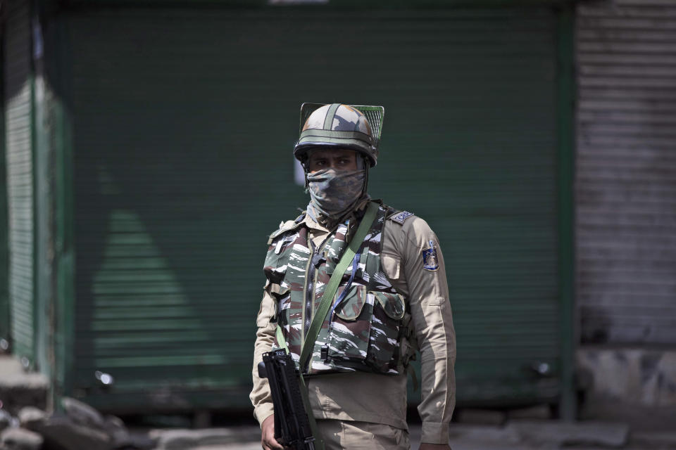 A paramilitary soldier stands guard during curfew in Srinagar, Indian controlled Kashmir, Tuesday, Aug. 4, 2020. Authorities clamped a curfew in many parts of Indian-controlled Kashmir on Tuesday, a day ahead of the first anniversary of India’s controversial decision to revoke the disputed region’s semi-autonomy. Shahid Iqbal Choudhary, a civil administrator, said the security lockdown was clamped in the region’s main city of Srinagar in view of information about protests planned by anti-India groups to mark Aug. 5 as “black day." (AP Photo/Mukhtar Khan)