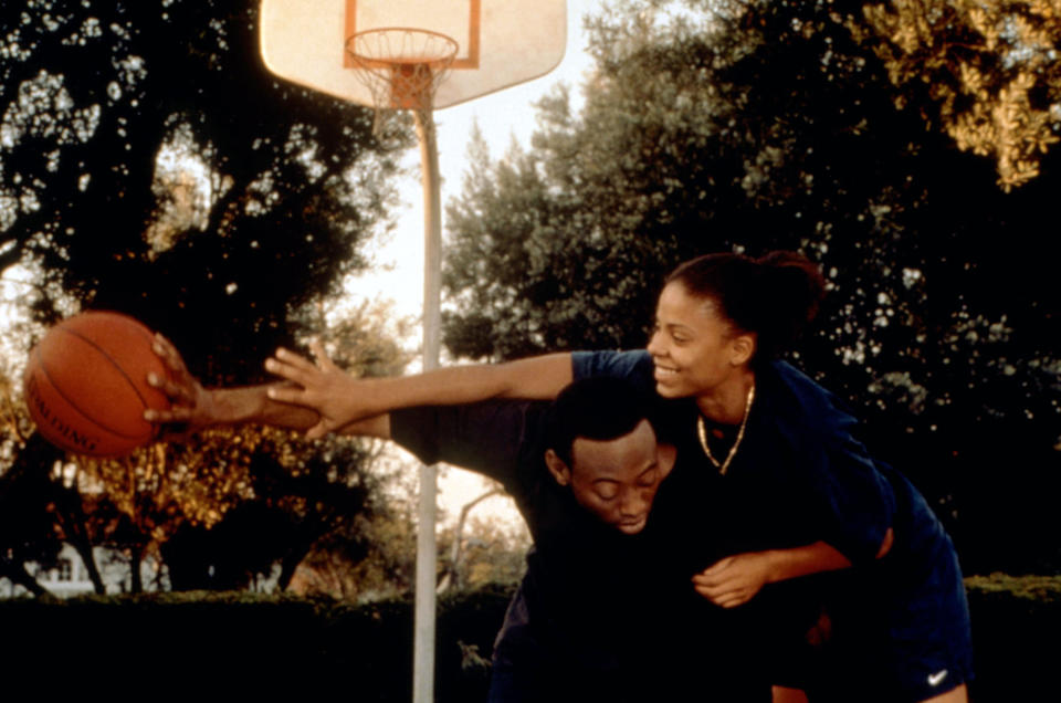 Omar Epps and Sanaa Lathan smiling and playing basketball