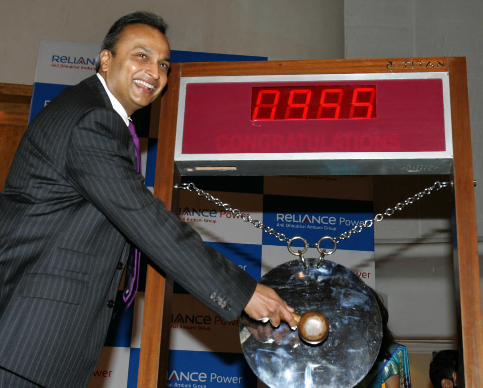 Chairman of India's Reliance Power Anil Ambani sounds a gong at a ceremony to mark the listing of the company at The Bombay Stock Exchange (BSE) in Mumbai on February 11, 2008. Reliance Power, which managed a record initial share offer last month, fell as much as 13.5 percent in its debut on Indian bourses on concern about the global economic outlook. After a brief gain to 599 Indian Rupees (USD 15.08), it quickly fell to as low as 389 Indian Rupees (USD 9.80) on the exchange. Reliance Power aims to build a dozen major power plants in the next decade in India and had snapped up 2.9 billion USD in an eagerly subscribed initial share sale in January 2008, priced at 450 Indian Rupees (11.54 dollars). AFP PHOTO/Sajjad HUSSAIN