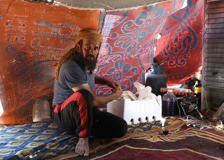 Mirad Ghabaghbi, sits inside a tent near the Israeli-occupied Golan Heights in Quneitra, Syria July 2, 2018. Picture taken July 2, 2018. REUTERS/Alaa Al-Faqir