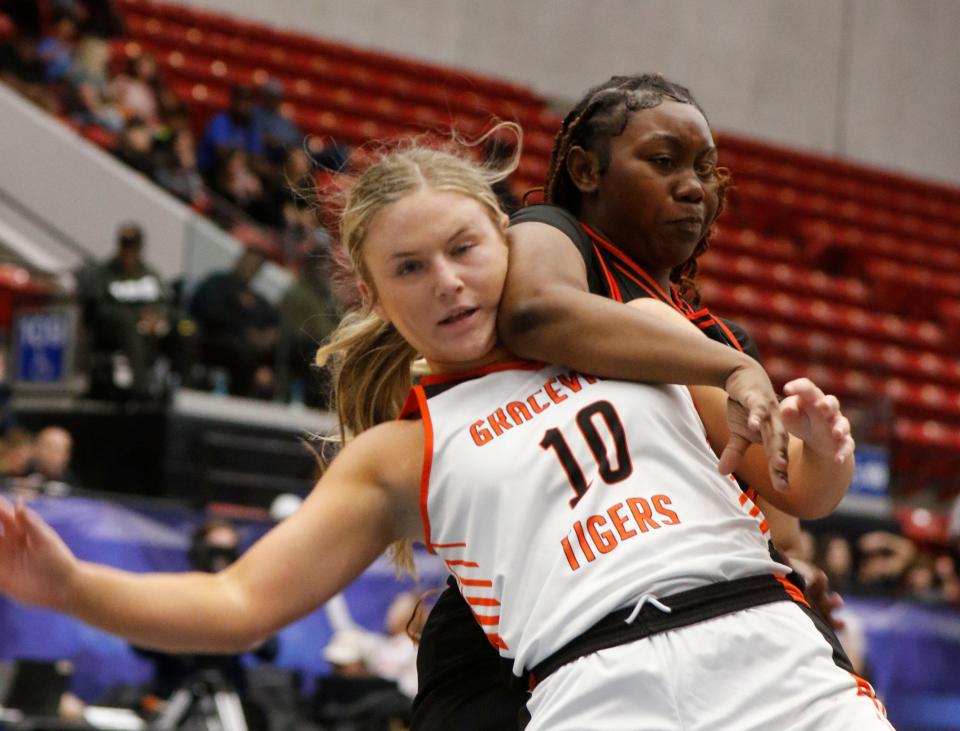 Tigers #10 Brianna Adams battles Hornets #23 Jhalea Jackson under the basket in the first half.  Hawthorne Hs Hornets vs the Graceville Tigers at the FHSAA Girls 1A Championship at the RP Funding Center in Lakeland Fl. Saturday March 2nd 2024, 2024 Photo by Calvin Knight