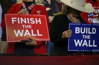 Supporters hold placards as U.S. President Donald Trump holds a rally at El Paso County Coliseum in El Paso