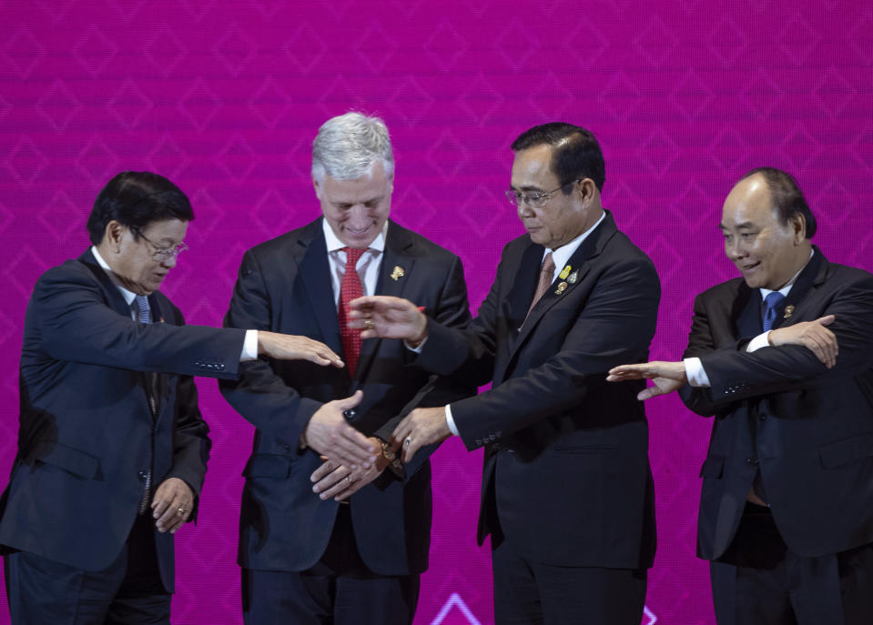 In this Monday, Nov. 4, 2019, file photo, U.S. National Security Adviser Robert O'Brien, second left, with ASEAN leaders, from left, Laos Prime Minister Thongloun Sisoulith, Thailand Prime Minister Prayuth Chan-ocha, and Vietnamese Prime Minister Nguyen Xuan Phuc prepares to shake hands in traditional ASEAN-way during ASEAN-US summit in Nonthaburi, Thailand. (AP Photo/Gemunu Amarasinghe, File)