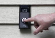 In this Tuesday, July 16, 2019, photo, Ernie Field pushes the doorbell on his Ring doorbell camera at his home in Wolcott, Conn. Police departments around the country are partnering with the doorbell camera company Ring in an effort to fight crime and create a sort of modern-day neighborhood watch. (AP Photo/Jessica Hill)