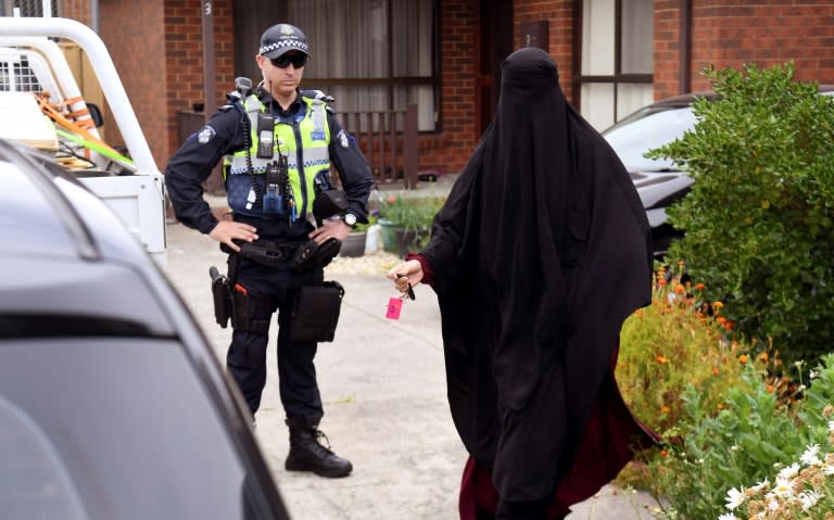 A woman was seen leaving a Melbourne house which police raided after three men were arrested for allegedly plotting terror attacks in the city