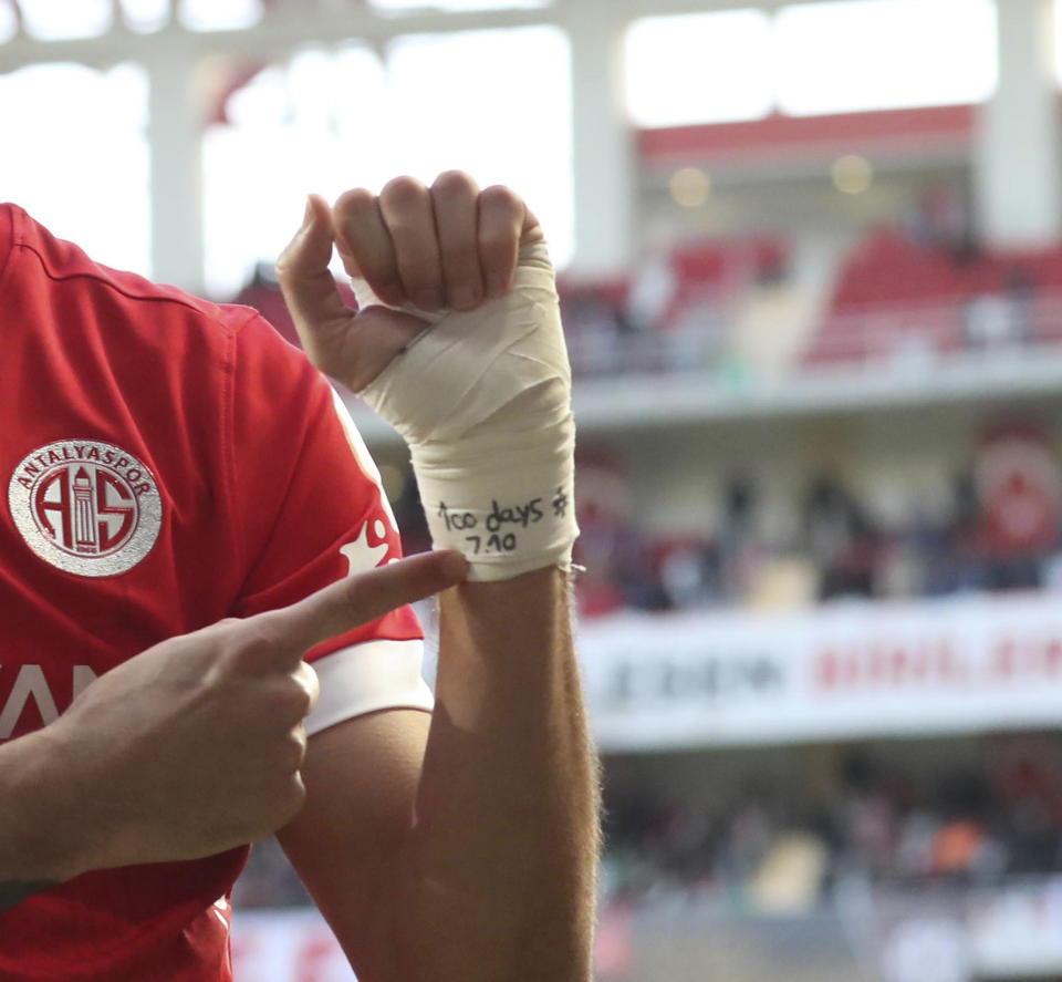 Antalyaspor's Sagiv Jehezkel points a message in his bandage that reads: "100 days. 7.10" as he celebrates after scoring his side's first goal during a Turkish Super Lig soccer match between Antalyaspor and Trabzonspor in Antalya, southern Turkey, Sunday, Jan. 14, 2024. Turkish authorities have detained Turkish top-flight soccer club Antalyaspor's Israeli player Sagiv Jehezkel for questioning after he displayed solidarity with people held hostage by the Hamas militant organization during a league game. (Adem Akalan/DHA via AP)