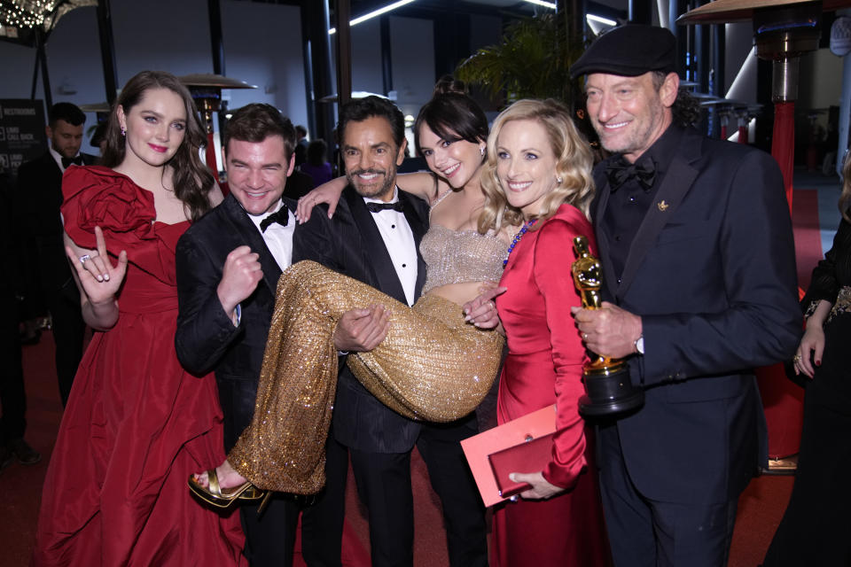 Amy Forsyth, from left, Daniel Durant, Eugenio Derbez, Emilia Jones, Marlee Matlin and Troy Kotsur, winner of the award for best performance by an actor in a leading role for "CODA," attend the Governors Ball after the Oscars on Sunday, March 27, 2022, at the Dolby Theatre in Los Angeles. (AP Photo/John Locher)