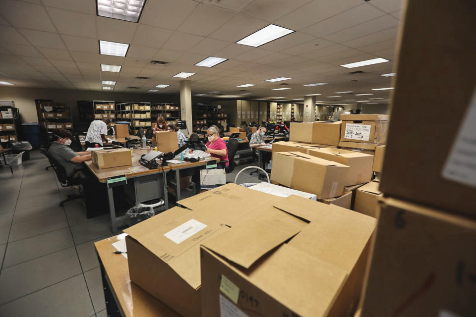 Employees and contracted staff toil through gun records at the ATF’s National Tracing Center, located in Martinsburg, W.Va. (Peter Kavanagh / NBC News)
