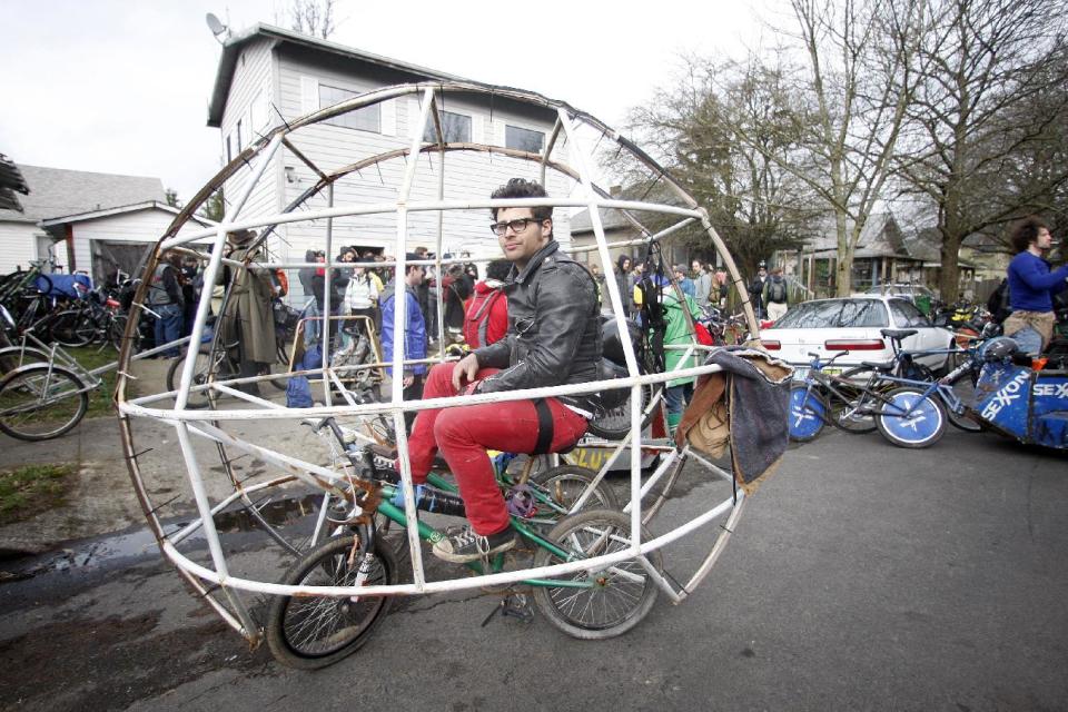 Zane Fischer, sits in his hamster ball bike before a “Ben Hur”-like chariot race at Chariot Wars during a three-day Mini Bike Winter Olympics Saturday, Feb.18, 2012, in Portland, Ore. Armed, variously, with all manner of foam-padded apparatus, at least five teams did battle on Saturday under gray skies for the pleasure of hoisting a three-foot-tall, homemade skull-bearing piece of welded junk, called the “Ben Hurt” trophy. (AP Photo/Rick Bowmer)