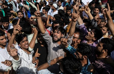 Kashmiris attend a protest after the Eid-al-Adha prayers at a mosque during restrictions after the scrapping of the special constitutional status for Kashmir by the Indian government, in Srinagar