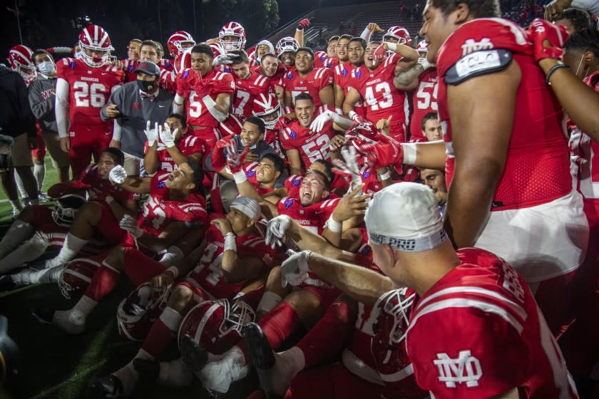 SANTA ANA, CA - APRIL 17, 2021: Mater Dei celebrates their 34-17 win over St John Bosco at Santa Ana Stadium on April 17, 2021 in Santa Ana, California.(Gina Ferazzi / Los Angeles Times)