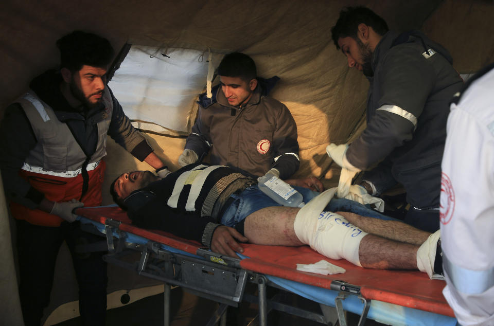 Medics treat a wounded protestor after he was shot, during a protest near the fence of the Gaza Strip border with Israel, at the field clinic tent near Beit Lahiya, northern Gaza Strip, Tuesday, Feb. 19, 2019. (AP Photo/Adel Hana)