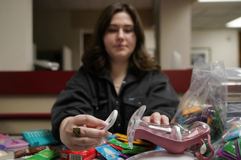 Abby Tow, a Sexual Health Peer Educator at the University of Oklahoma, demonstrates proper use of a birth control ring at the health center on campus, Wednesday, May 10, 2023, in Norman, Okla. Tow said she wonders if helicopter parenting has played a role in what she calls the "baby-fication of our generation". (AP Photo/Sue Ogrocki)