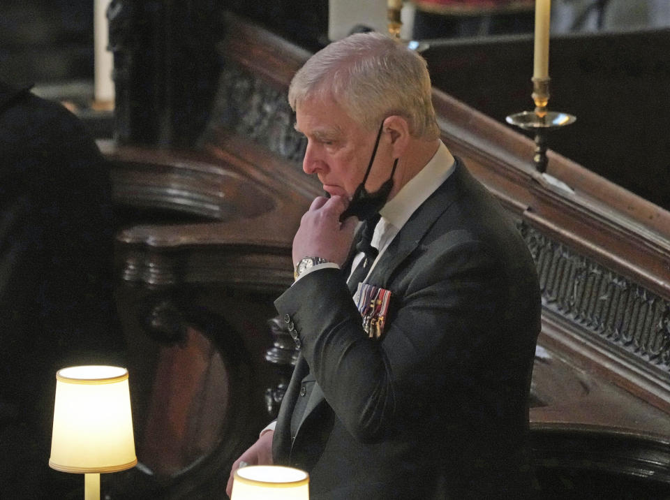 FILE - Britain's Prince Andrew stands inside St. George's Chapel during the funeral of his father, Prince Philip, at Windsor Castle, Windsor, England, Saturday April 17, 2021. Longtime Jeffrey Epstein accuser Virginia Giuffre sued Prince Andrew on Monday, Aug. 9, 2021, saying he sexually assaulted her when she was 17. Lawyers for Giuffre filed the lawsuit in Manhattan federal court. (Yui Mok/Pool via AP, File)