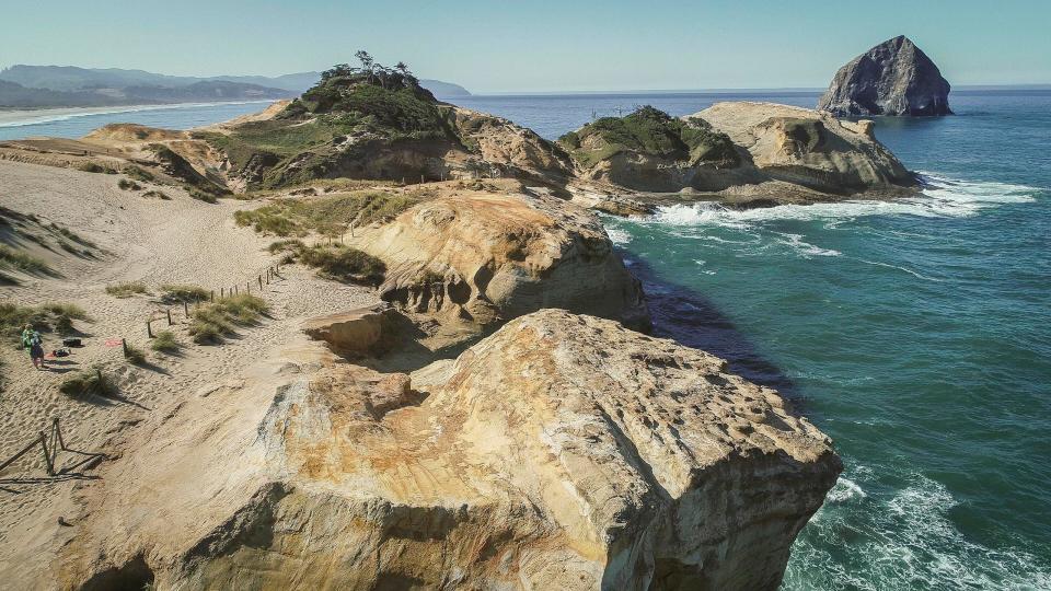 Views of Cape Kiwanda State Natural Area, a state park in Pacific City, Oregon. The 185-acre site was acquired by purchase and by a gift from B. A. McPhillips in 1973 and is a popular destination for locals and tourists. Eight people have died falling into the ocean and onto the rocks since 2009 prompting park officials to put up fencing around the area while preserving great views from established viewpoints.