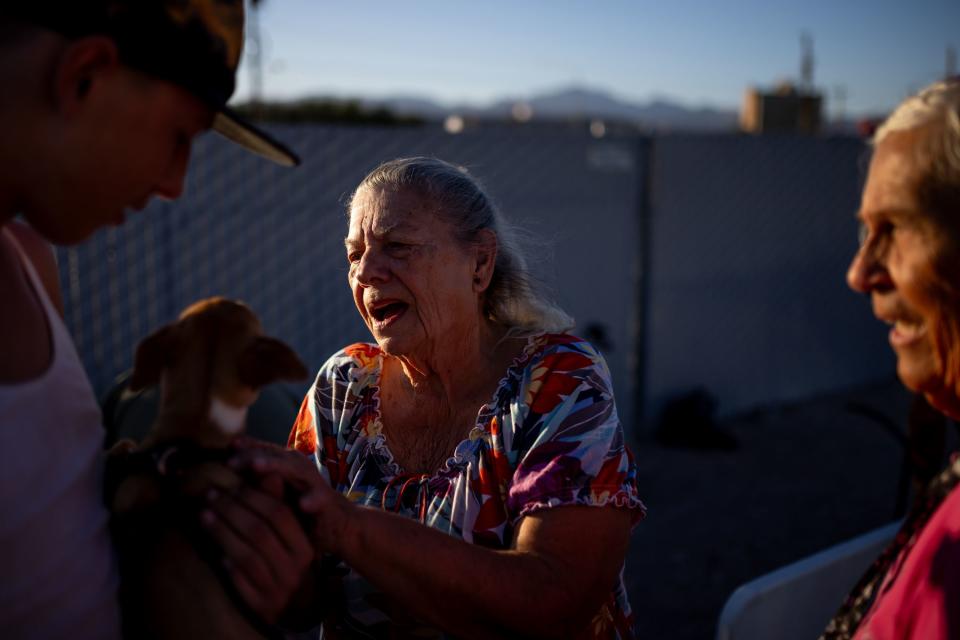 Norma Thornton greets a dog after distributing a free meal to homeless people in Bullhead City, Ariz., on Tuesday, Oct. 24, 2023. | Spenser Heaps, Deseret News