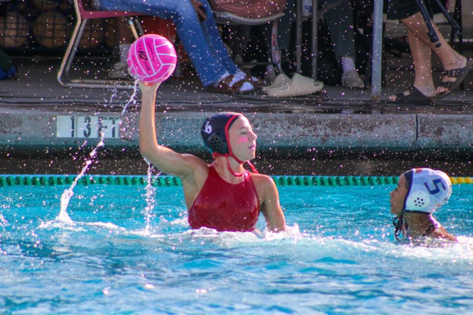 Ripon's Reyna Biedermann prepares to throw the ball during one of the Indians girls' water polo games in the 2023-24 season.