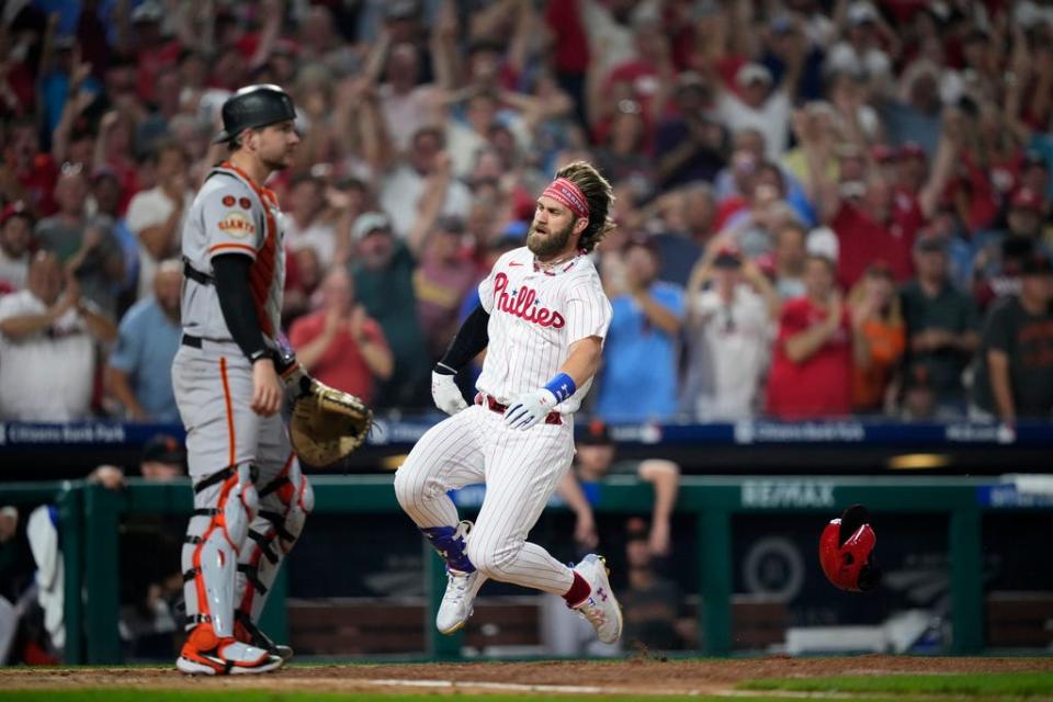 Philadelphia Phillies' Bryce Harper slides after hitting an inside-the-park home run during a baseball game, Monday, Aug. 21, 2023, in Philadelphia. (AP Photo/Matt Slocum)