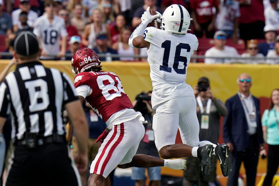 Penn State safety Ji'Ayir Brown (16) intercepts a pass intended for Arkansas wide receiver Warren Thompson (84) during the first half of the Outback Bowl.