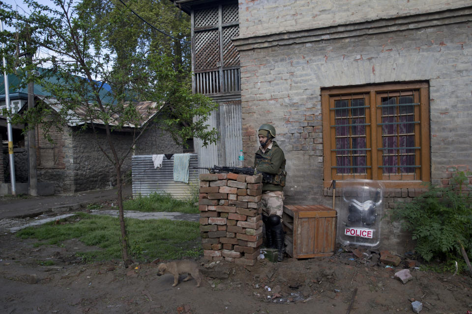 An Indian paramilitary soldier stands guard at a polling station during the second phase of India's general elections, in Srinagar, Indian controlled Kashmir, Thursday, April 18, 2019. Kashmiri separatist leaders who challenge India's sovereignty over the disputed region have called for a boycott of the vote. Most polling stations in Srinagar and Budgam areas of Kashmir looked deserted in the morning with more armed police, paramilitary soldiers and election staff present than voters. (AP Photo/ Dar Yasin)