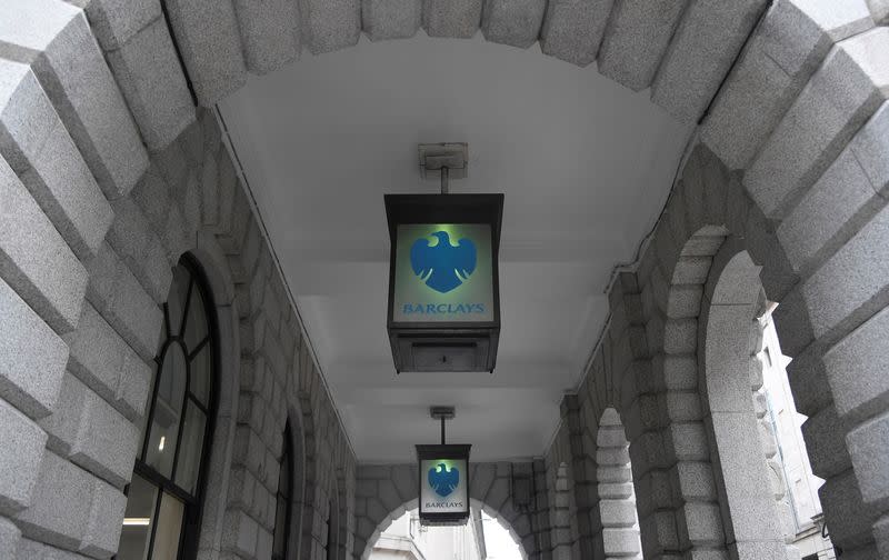 The logo of Barclays bank is seen on glass lamps outside of a branch of the bank in the City of London financial district in London