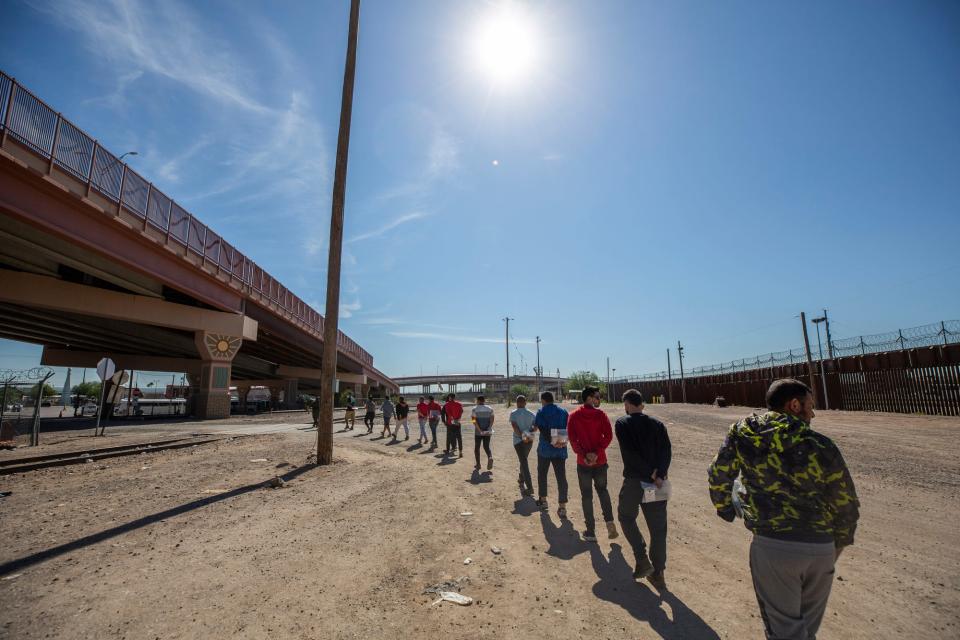 Migrants are filed and led by Customs and Border Protection to vans that will transport them after having crossed the Rio Grande river from Ciudad Juarez, Mexico to El Paso, Texas, seeking asylum on Tuesday.