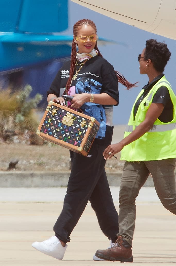 Rihanna carries a Louis vintage Vuitton x Takashi Murakami vanity box. - Credit: Splash News