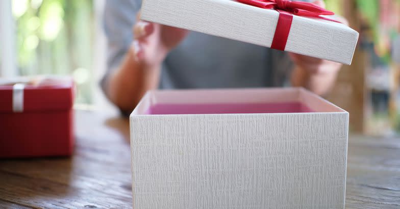 Opening Gift Box On Wooden Table 